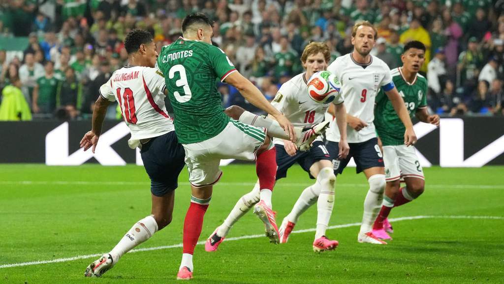 England players celebrating a goal against Mexico during the World Cup 2026 match at Estadio Azteca