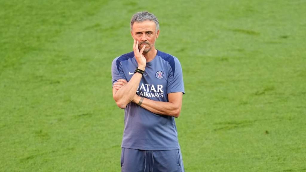 PSG manager Luis Enrique contemplating squad tactical decisions on the pitch