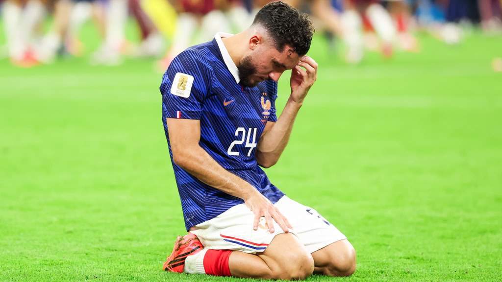 Rayan Cherki appearing frustrated on the bench during France World Cup match